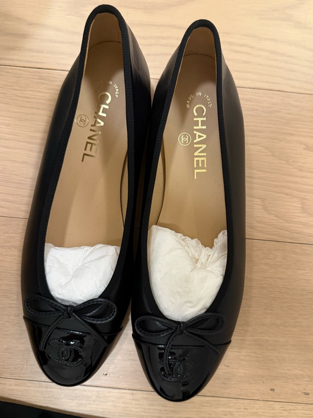 CHANEL Black Leather Ballet Flats with Patent Cap Toe and Bow